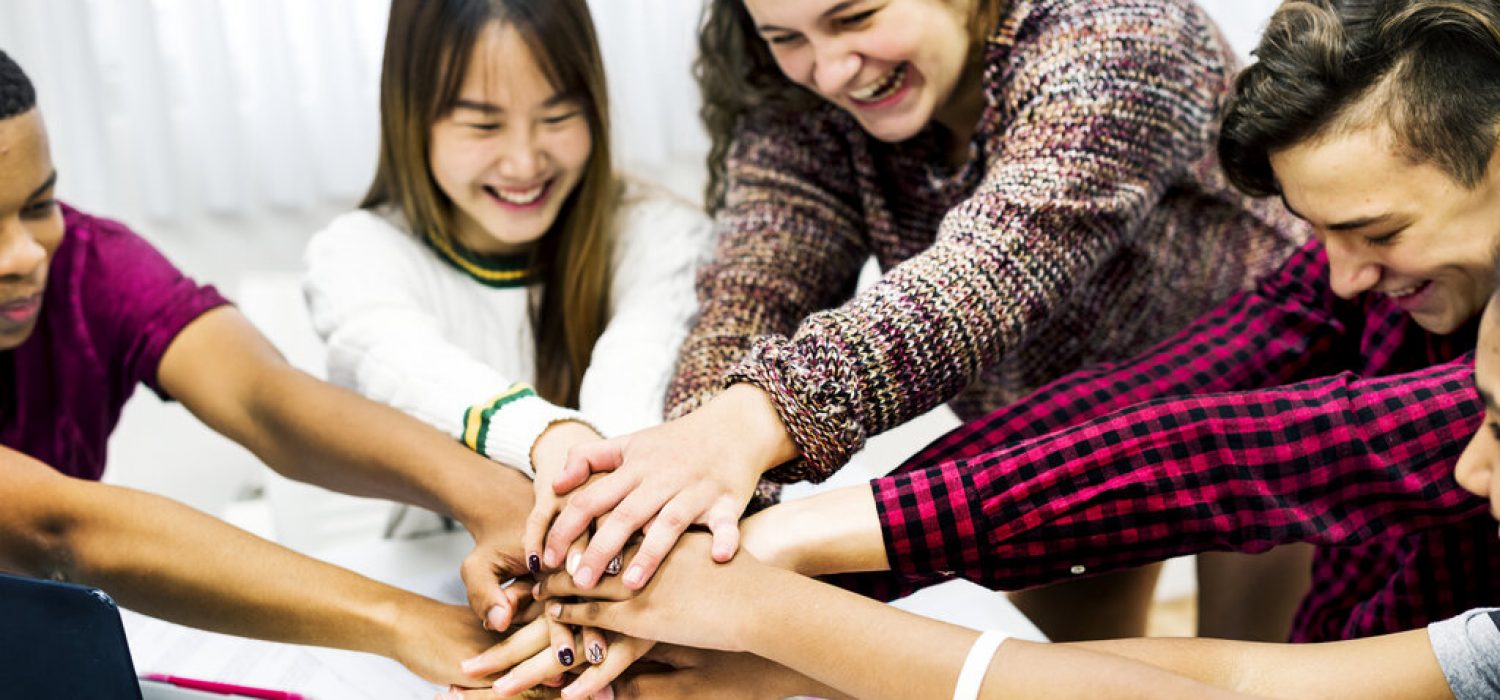 Classmates joining hands teamwork and success concept